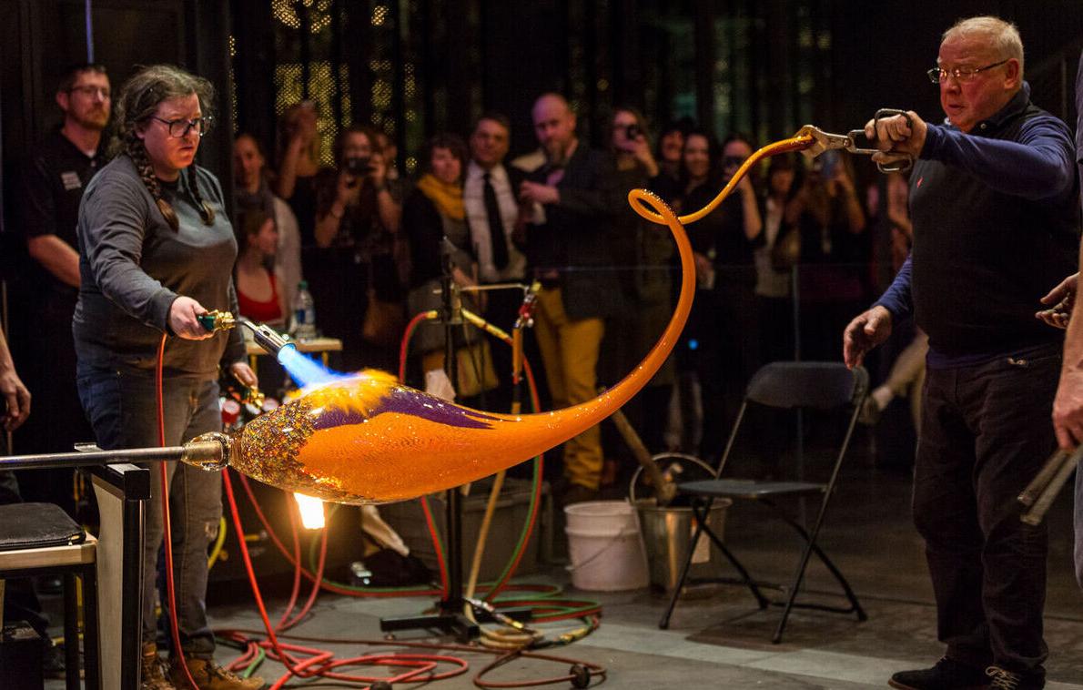 Many people looks on during a glassmaking demonstration at the Corning Museum of Glass